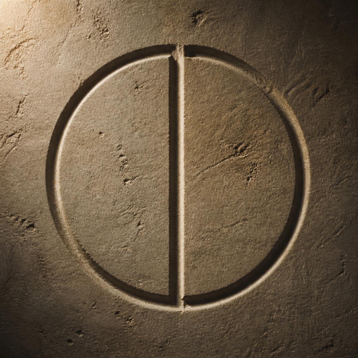 A carved circle interrupted by a straight incision in stone